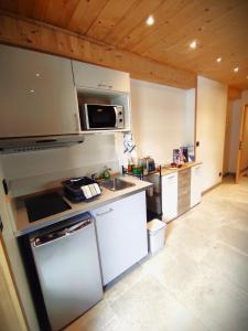 a kitchen with a sink and a stove at Studio Sainte Marie in Lanslebourg-Mont-Cenis