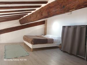 a bedroom with a bed and a wooden ceiling at Mas San Salvador in Bompas