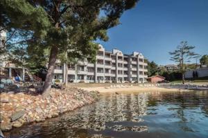 a view of a hotel from the water at LAKEFRONT PENTHOUSE FULLY UPGRADED PANORAMIC VIEWS BOAT SLIP INDOOR OUTDOOR POOL in Wisconsin Dells