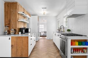 a kitchen with white counters and a stove top oven at Canterbury Cottage in Austin