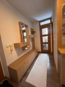a bathroom with a bench and a window and a door at Krásny apartmám CENTRUM in Martin