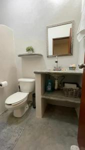 a bathroom with a white toilet and a sink at La Ventana Apartments Cactus 1 in La Ventana