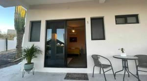 a patio with a table and chairs and a house at La Ventana Apartments Cactus 1 in La Ventana