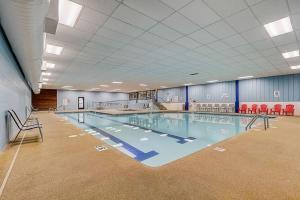 a large swimming pool in a large room at Sloane Condo for Families Golfers and Girls Trips in Wisconsin Dells