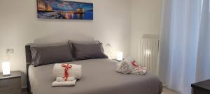 a bedroom with a bed with two towels on it at Erre Home in Naples +27 photos
