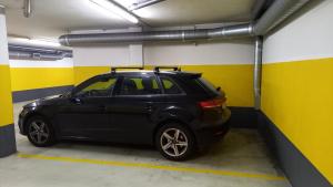 a black car parked in a parking garage at Porto FishLand Apartment in Matosinhos