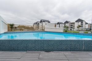 a swimming pool in front of some apartment buildings at Bella Cabana Luxury Apartment in Summerstrand