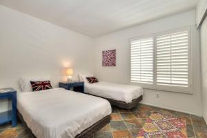 a bedroom with two beds and a window at Prime West Hollywood Designer Townhouse w Balcony in Los Angeles