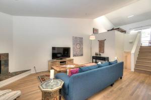 a living room with a blue couch and a table at Prime West Hollywood Designer Townhouse w Balcony in Los Angeles