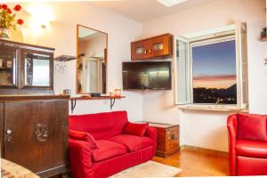 uma sala de estar com um sofá vermelho e uma janela em La Terrazza di Laurino em Laurino