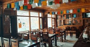a dining room with tables and chairs and a window at Hotel Lake view in Nako