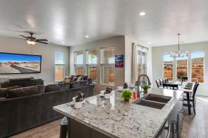 eine Küche und ein Wohnzimmer mit einer Couch und einem Tisch in der Unterkunft Paseos 1121 Sleeps 15, Private Hot Tub, Near Sand Hollow, and Quail Lake in Washington