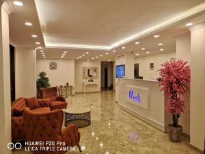 a lobby of a hotel with couches and a tv at Mavili Suites in Bostancı