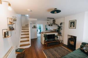 a living room with a staircase leading to a living room at Unique Cottage in the heart of Ulverston in Ulverston
