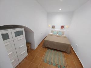 a small bedroom with a bed and a dresser at Cala Salions Balandro II Tossa de mar in Cañet de Mar