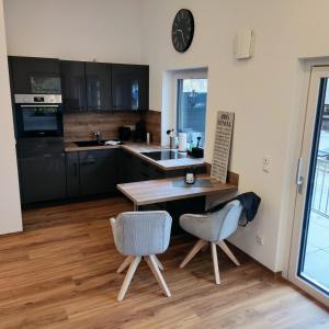 a kitchen with a table and two chairs and a counter at Ferienwohnung Lehmann in Blaichach