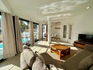 a living room with a couch and a table at Villa Son Blanc 6 in Sa Caleta