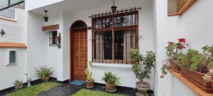 a front door of a house with potted plants at Huaca Host House in Lima