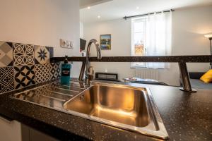 a kitchen with a stainless steel sink in a counter at #Nouveau#L'authentique#Centre in Cognac +17 photos