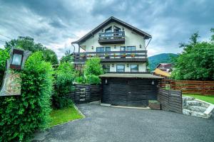 a large house with a garage in front of it at Casa Traian in Sinaia