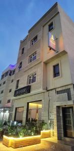 a building with a sign on the side of it at شقق مفروسة المشور in Laayoune