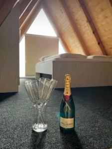 een fles champagne en een wijnglas op een tafel bij Bungalow Damiano's in Mrkonjić Grad