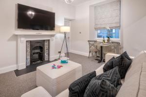 a living room with a couch and a fireplace at One Merewyke in Bowness-on-Windermere