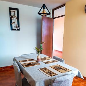 a dining room table with a blue table cloth and chairs at Apartamento Colca 's Home, cuenta con dos habitaciones in Chivay