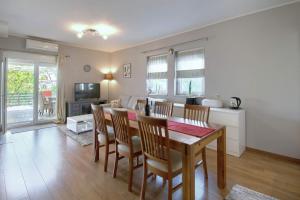 a kitchen and dining room with a table and chairs at Apartments Ana & Sara in Nova Vas