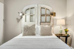 a white bed with a white headboard in a bedroom at The Village Inn by Dakota Gal Digs in Chicago