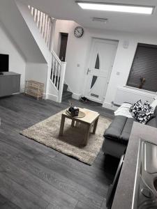 a living room with a couch and a coffee table at Home in Leicester! in Leicester