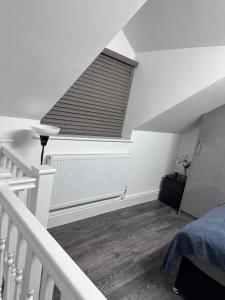 a attic room with a bed and a staircase at Home in Leicester! in Leicester