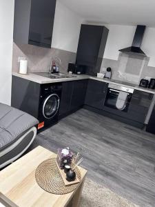a kitchen with a sink and a table in a room at Home in Leicester! in Leicester