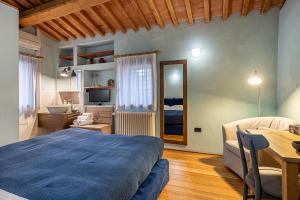 a bedroom with a bed and a desk and a table at Al Cantico in Mason Vicento