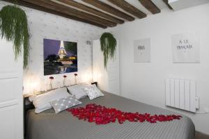 Un dormitorio con una cama con rosas rojas. en My Nest Inn Paris Panthéon - 31m2 - 2min du Panthéon, en París