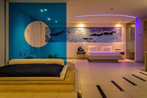 a bedroom with two beds and a painting on the wall at Nantai premium MOTEL in Florianópolis