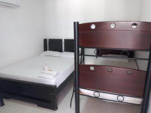 a small bedroom with a bunk bed with a ladder at Hotel Mileniun Valledupar in Valledupar