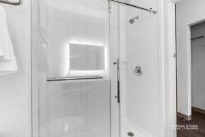 a shower with a glass door in a bathroom at AmeriK Suites Laredo Behind Mall Del Norte in Laredo