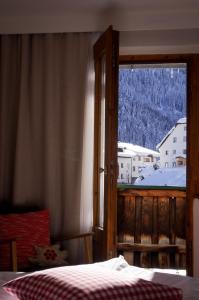 a bedroom with a bed and a large window at Hotel Tenne in Sankt Anton am Arlberg