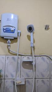 a toaster sitting on a wall in a bathroom at Under Volcano Village 1 in Ruhengeri