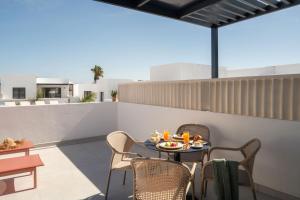 a patio with a table and chairs on a roof at Nazaret Beach - Adults only in Arrecife
