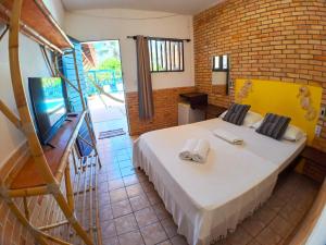 ein Schlafzimmer mit einem Bett mit Handtüchern darauf in der Unterkunft Pousada Praia do Amor in Pipa