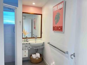 a bathroom with a sink and a mirror at Sunrise by Casuarina Beach in Casuarina
