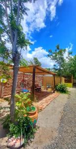 a patio with a tent and a table and chairs at Huaka Hostal in Cafayate