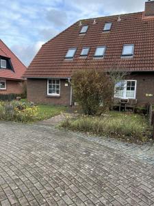 a brick house with a bench in front of it at Haus Delphin - Ferienwohnung 1 in Norderney
