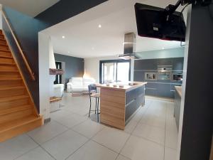 a kitchen with a counter and a living room at Villa Greg in Saint-Marcel-lès-Valence