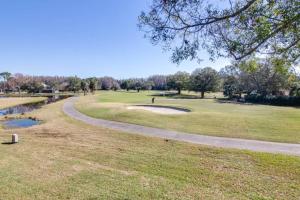 a golf course with a winding road next to a river at Matchless Luxury III on Mill Pond - 3168-3170 in Wesley Chapel