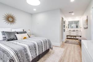 a white bedroom with a bed and a bathroom at Matchless Luxury III on Mill Pond - 3168-3170 in Wesley Chapel