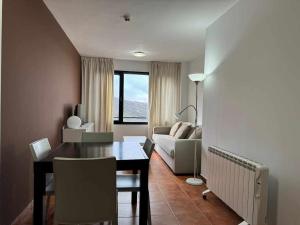 a living room with a dining room table and a couch at Apartamento Girasol in Sierra Nevada