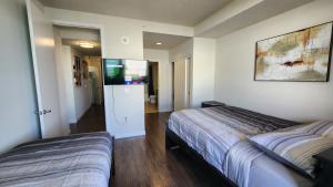 a bedroom with two beds and a flat screen tv at Amazing 2Bdr Home Must See DTLA in Los Angeles